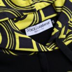 Yellow and black hoodie with brand label on front