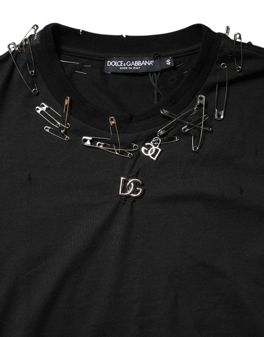 Black shirt with multiple pins and clips attached to it