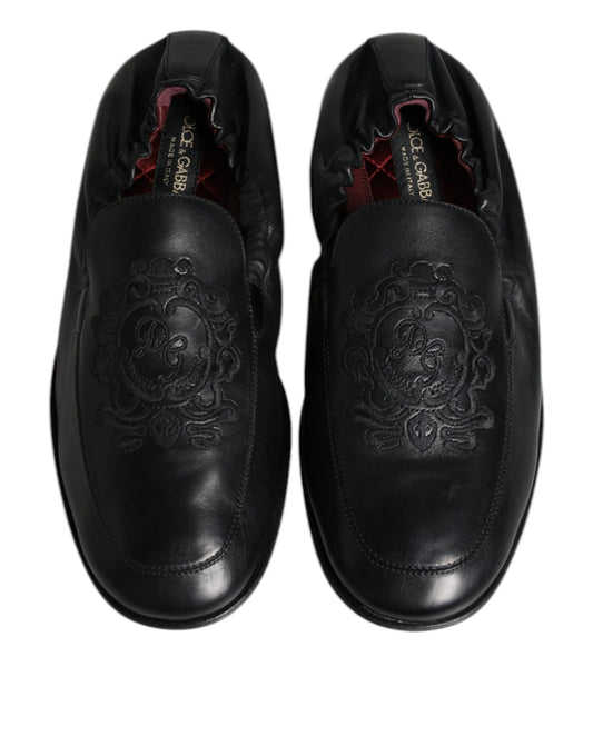 Pair of black leather shoes with embossed design on side