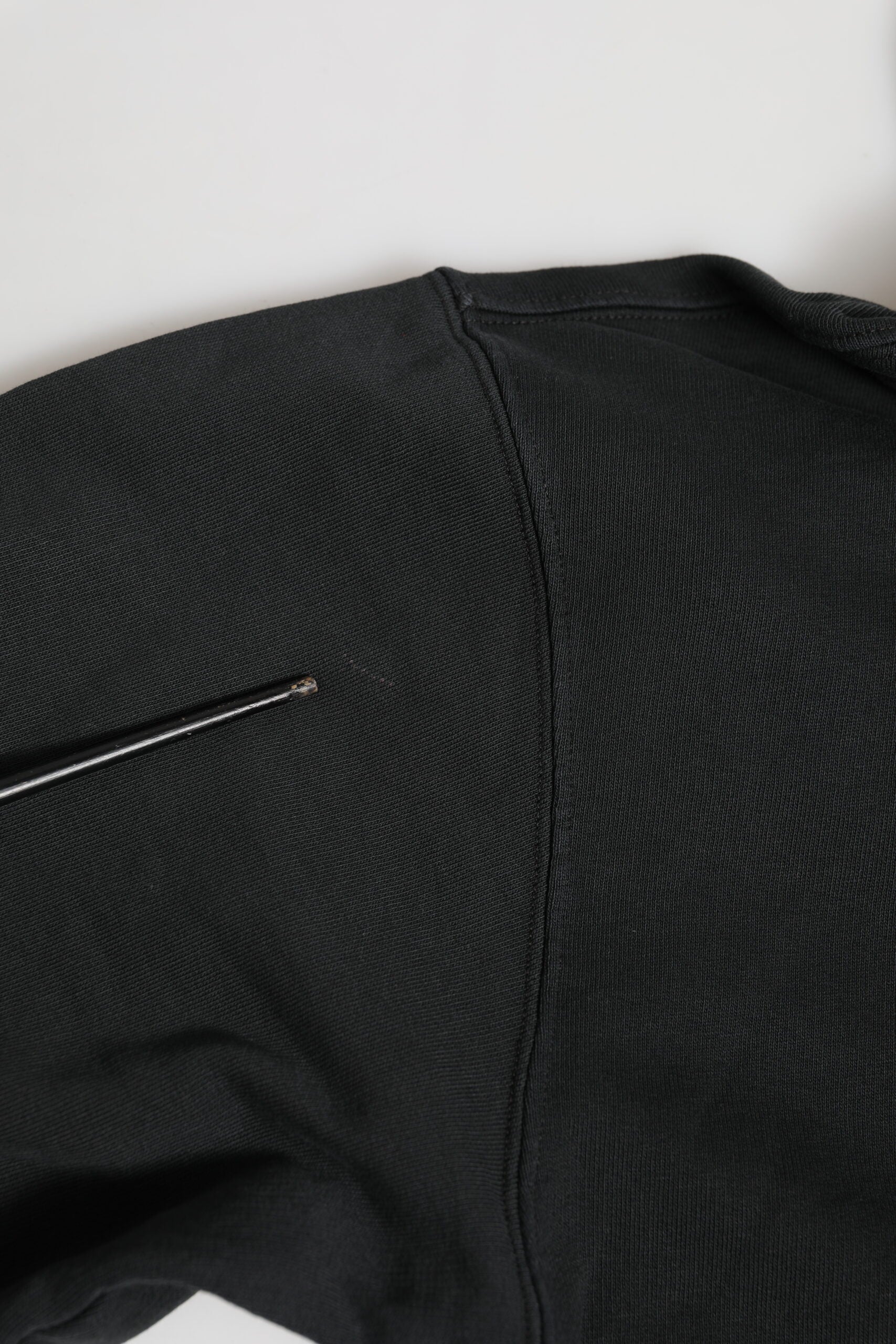 Black knitted sweater with ribbed cuffs and hem