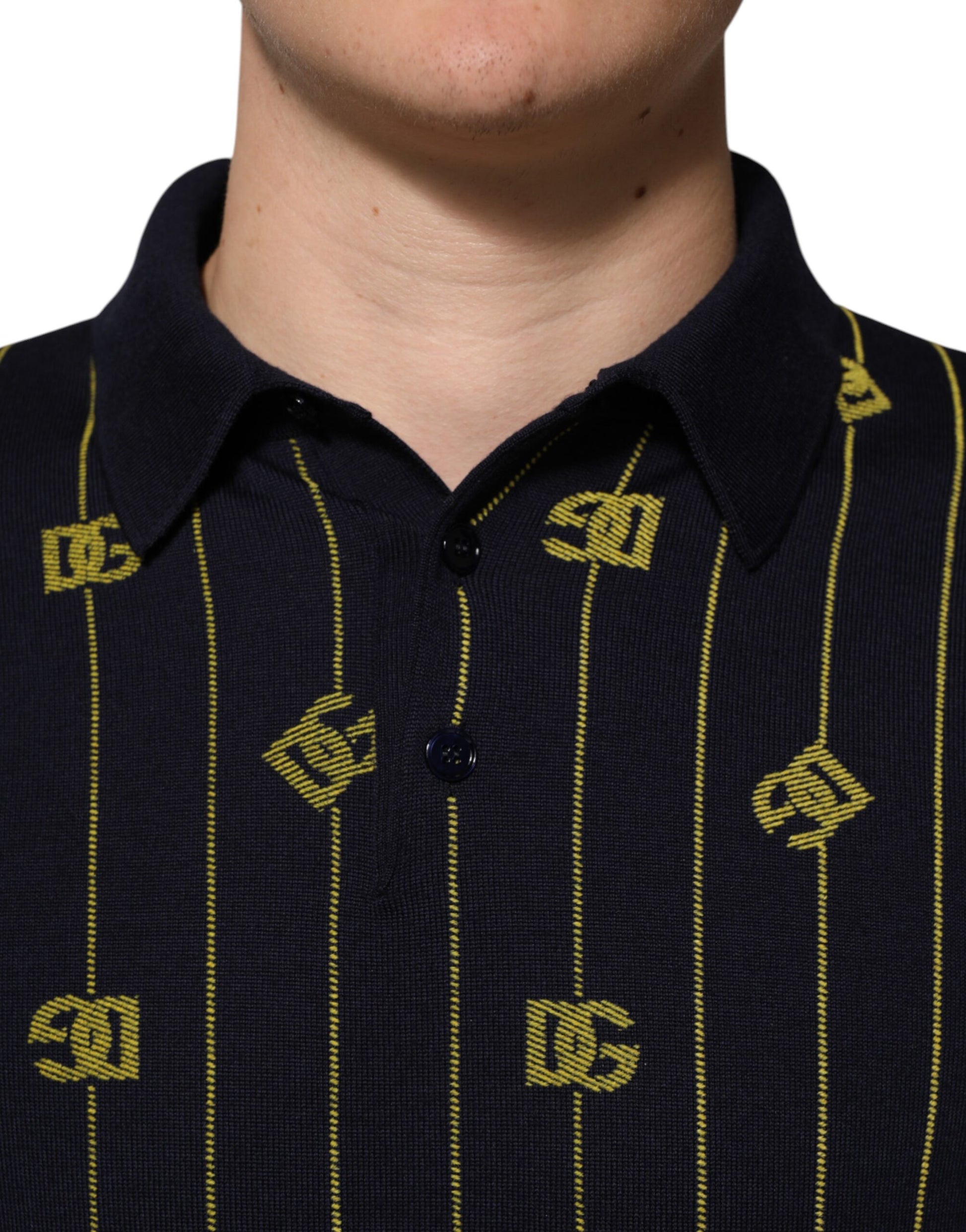 Man wearing dark blue polo shirt with yellow stripes and letters