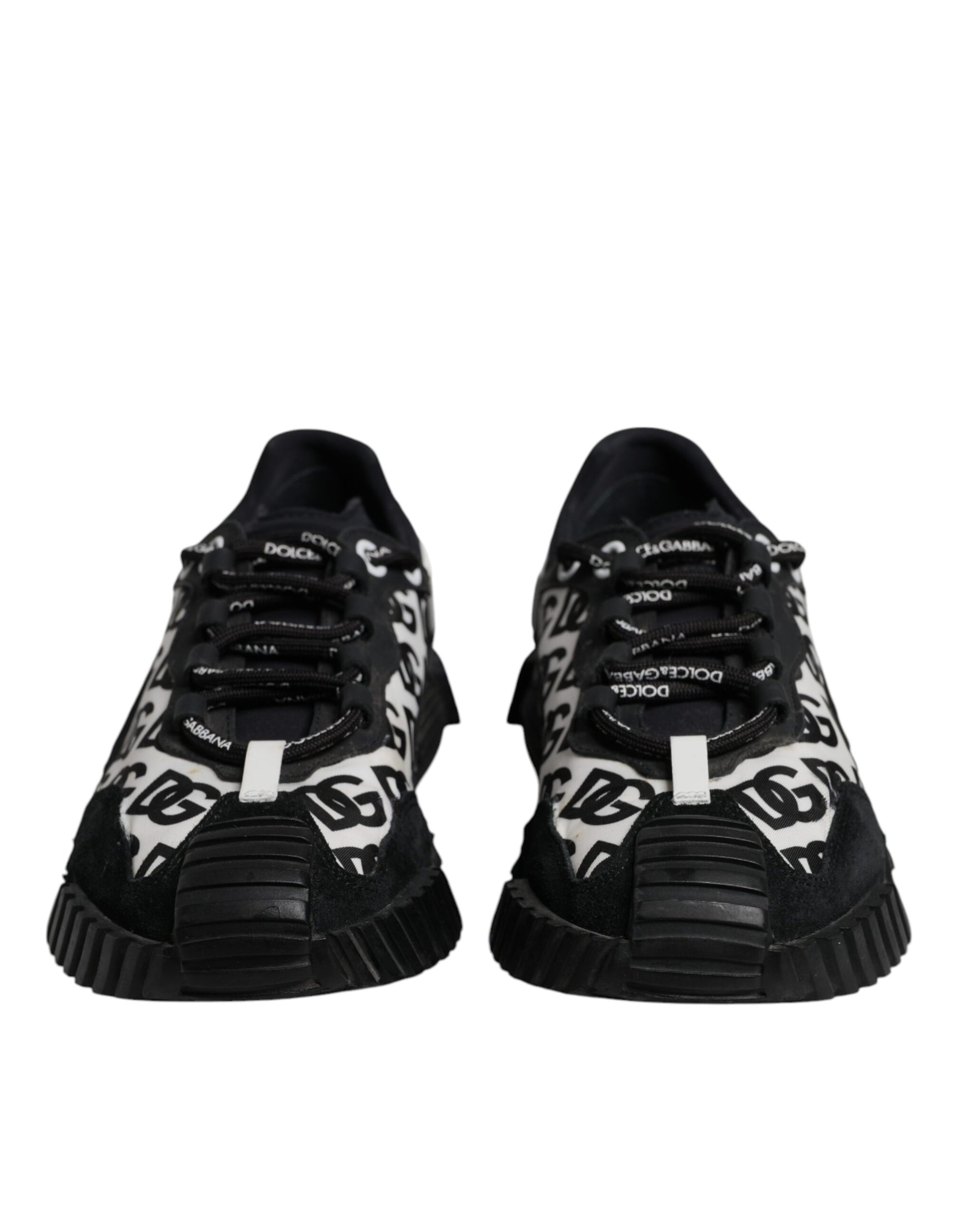 Pair of black sneakers with white laces and patterned design on side