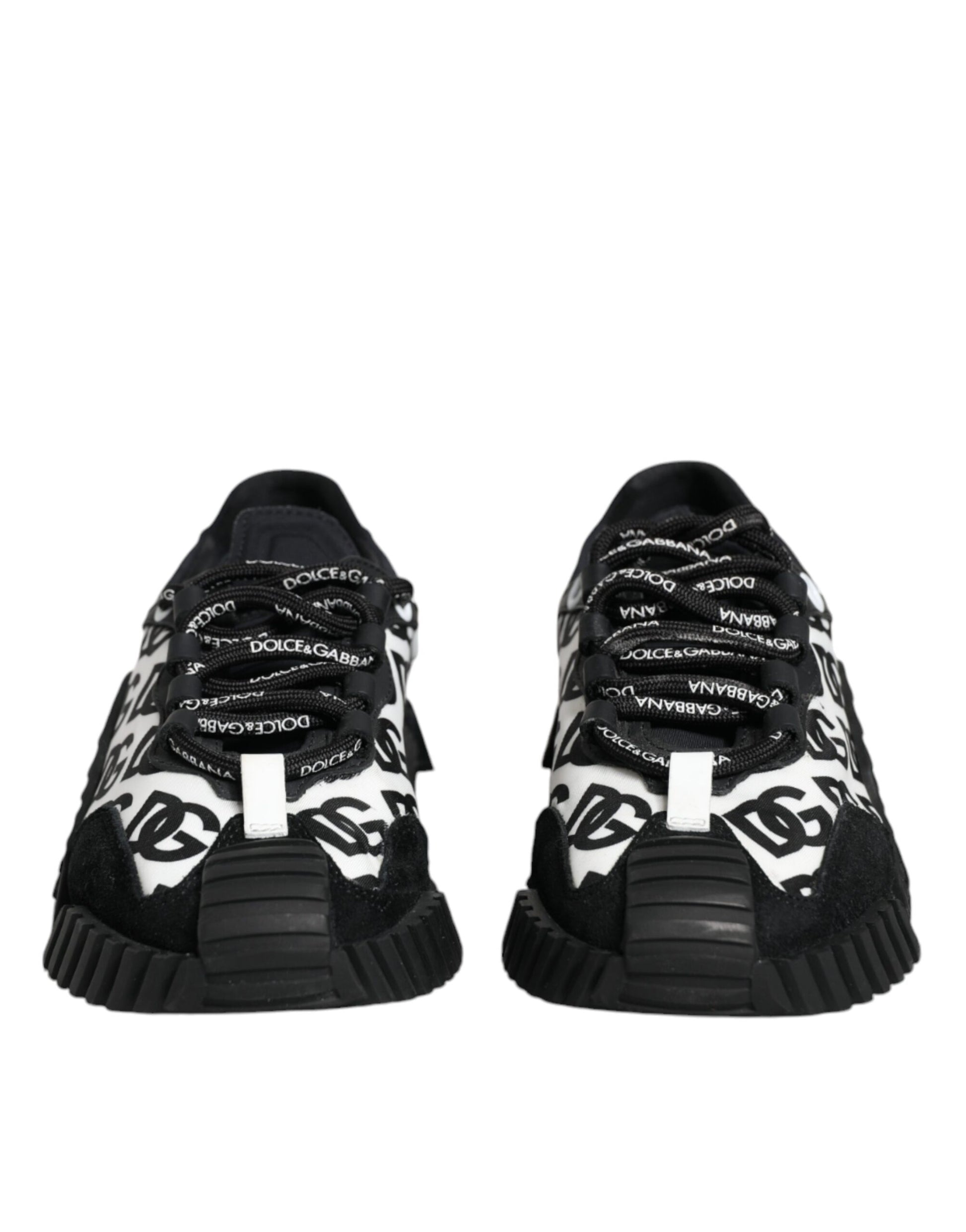 Pair of black sneakers with white laces and logo text on side
