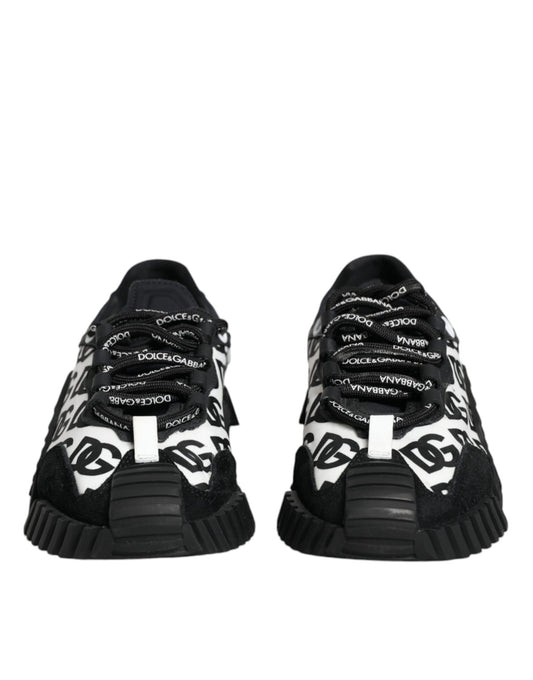 Pair of black sneakers with white laces and logo text on side