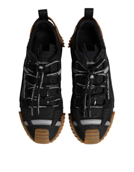 Pair of black lace-up sneakers with white logo and brown sole