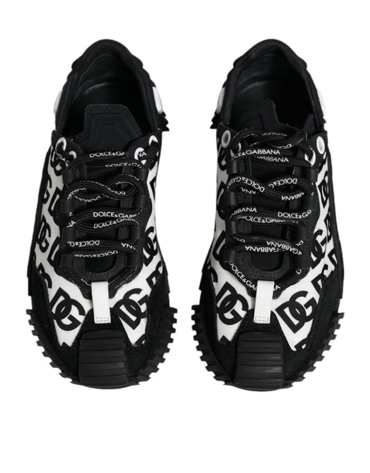 Pair of black lace-up sneakers with white logo print and chunky sole