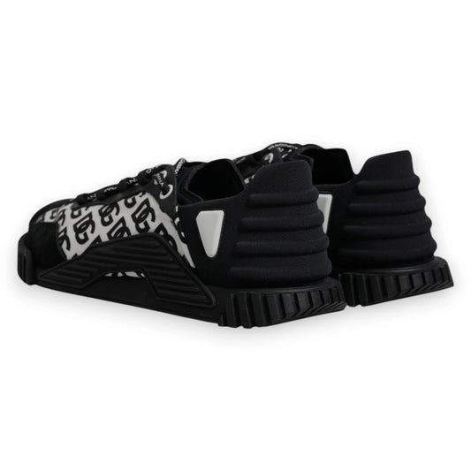 A pair of black lace-up sneakers with a logo on the side, featuring a chunky sole design