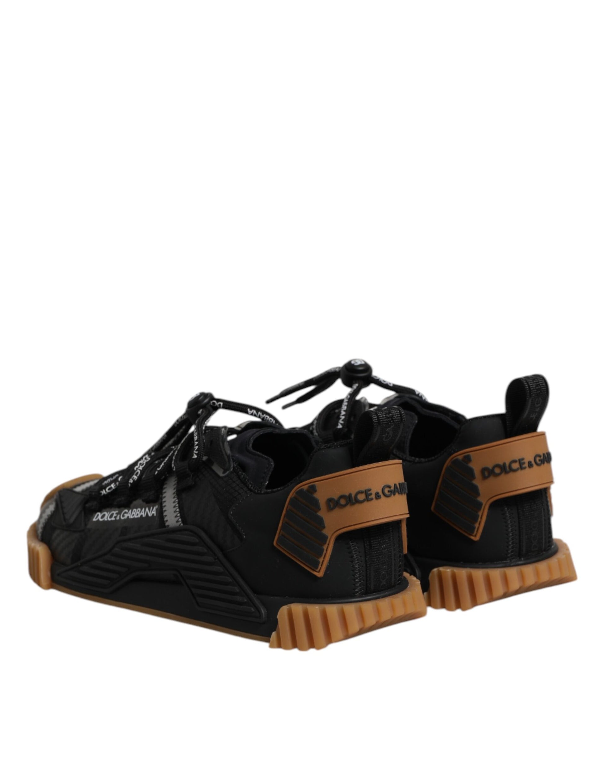 A pair of black lace-up sneakers with orange accents and a logo on the side
