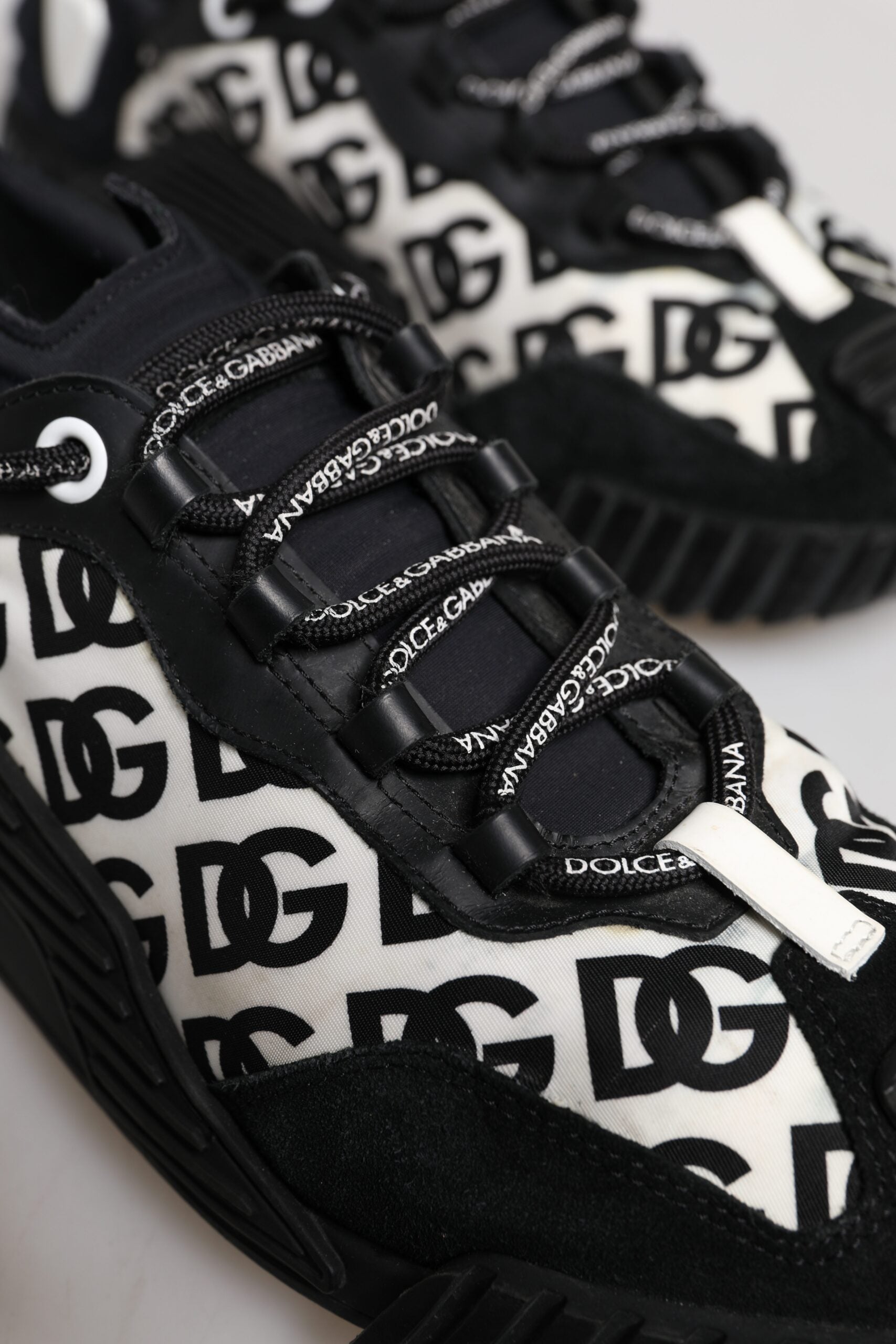 Black and white sneakers with brand name on side