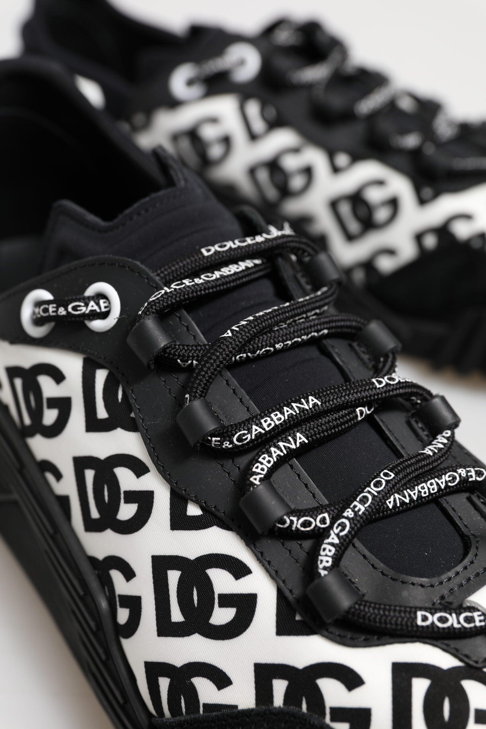 Black and white sneakers with brand names on side