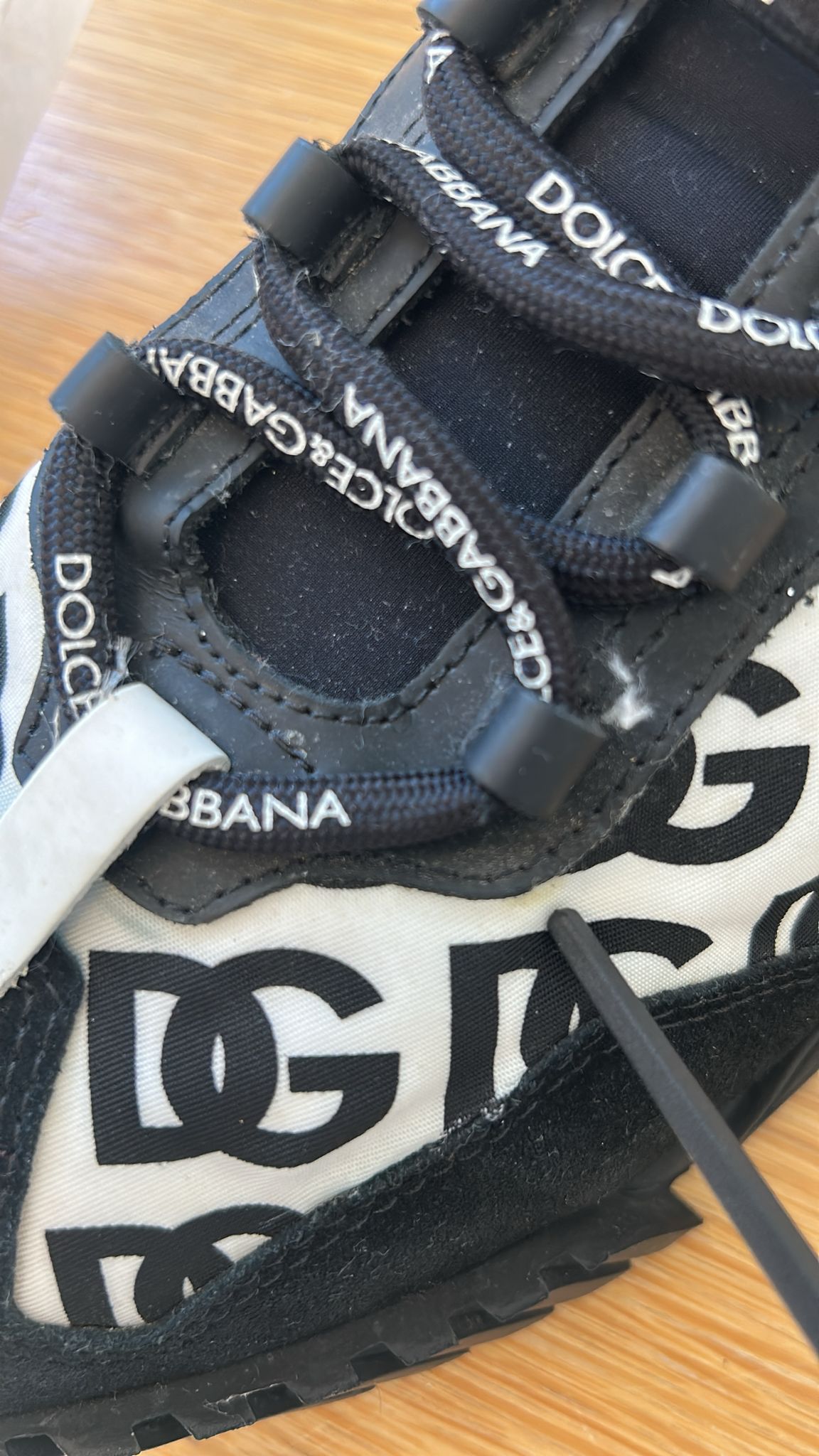 A pair of black lace-up sneakers with white and grey logos