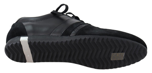 Pair of black sneakers with white laces and a silver logo on the side