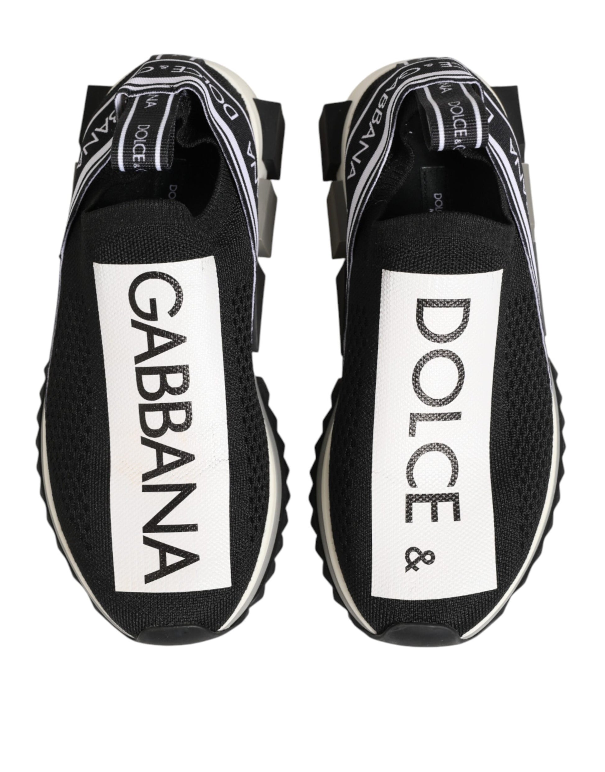 Pair of black sneakers with white brand names on side