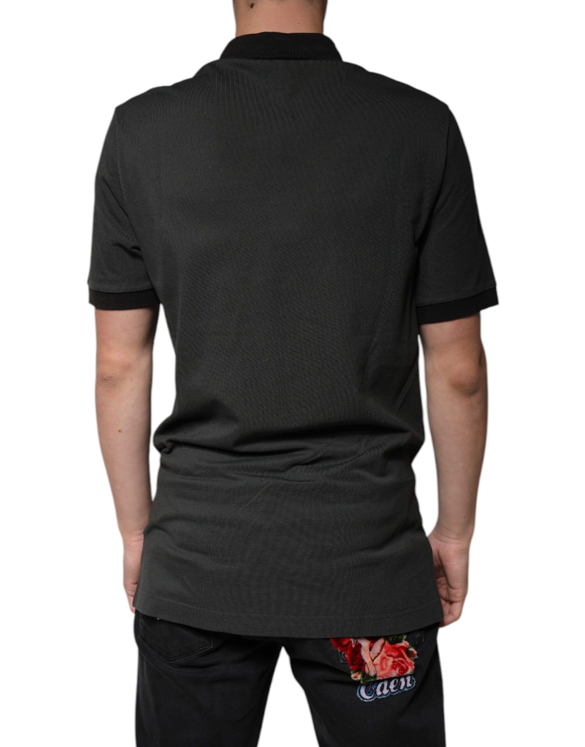 Man wearing dark polo shirt with logo on back