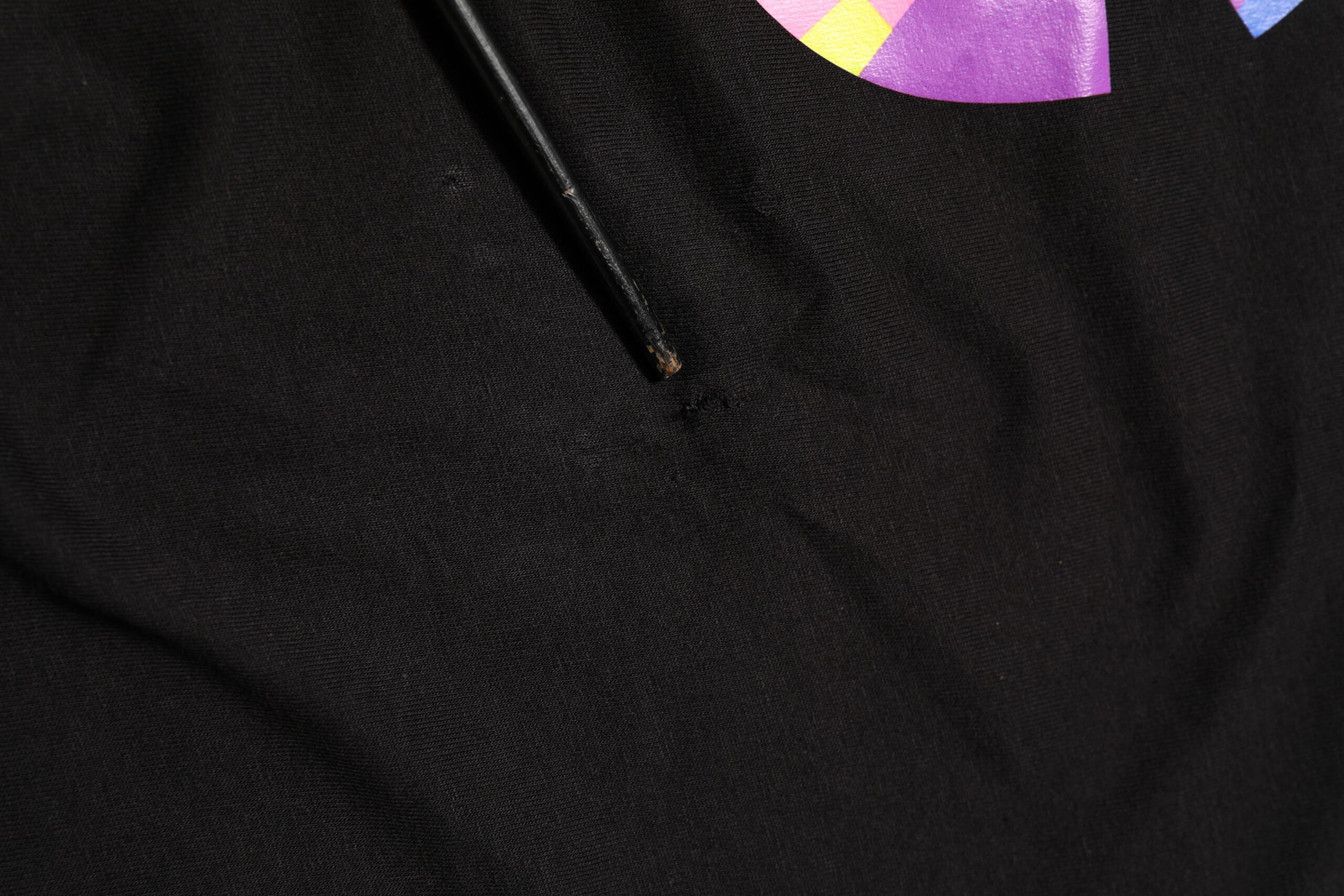Black fabric with a hole in it