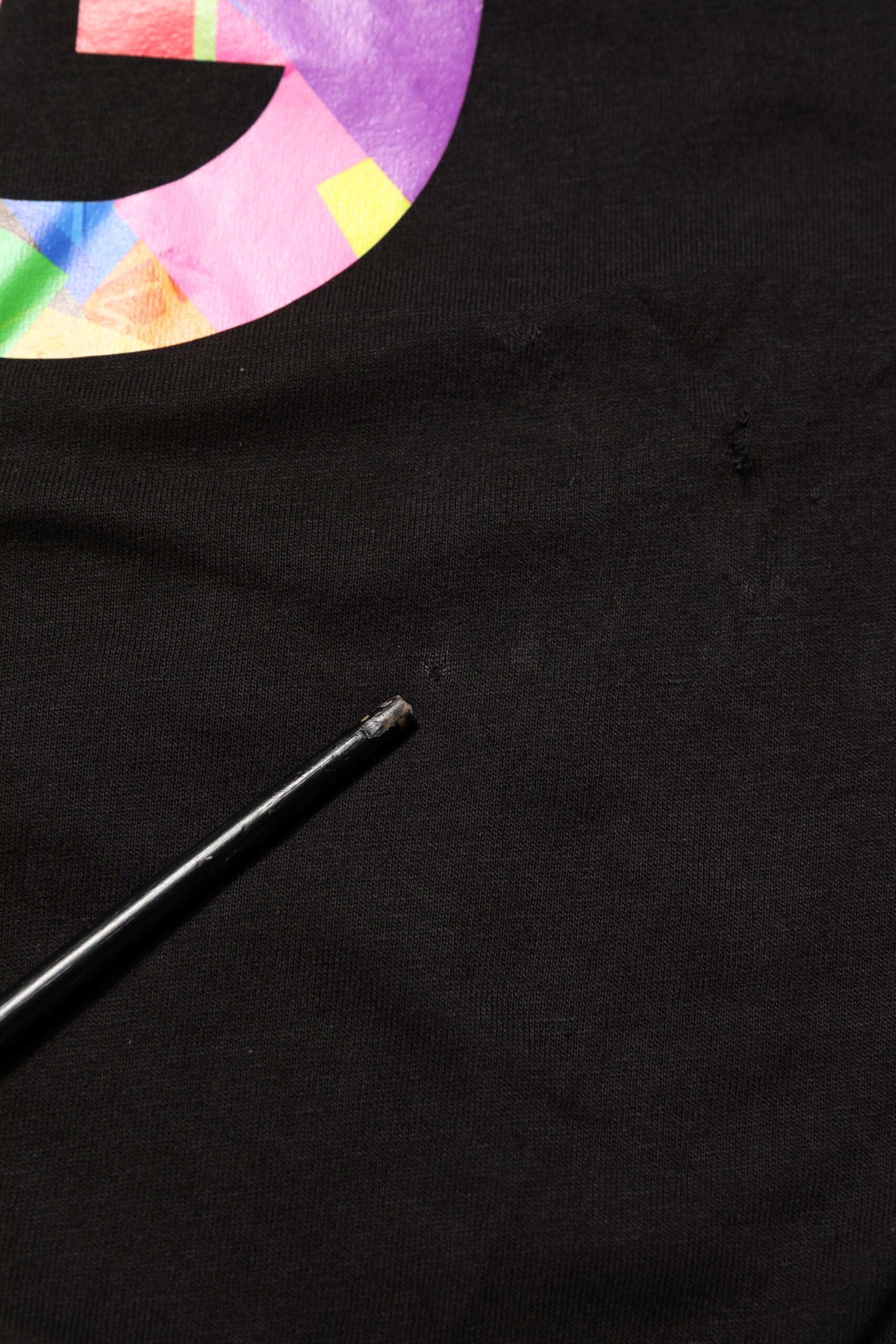 Black t-shirt with colorful design on front