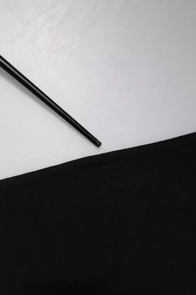 Black pencil on white surface