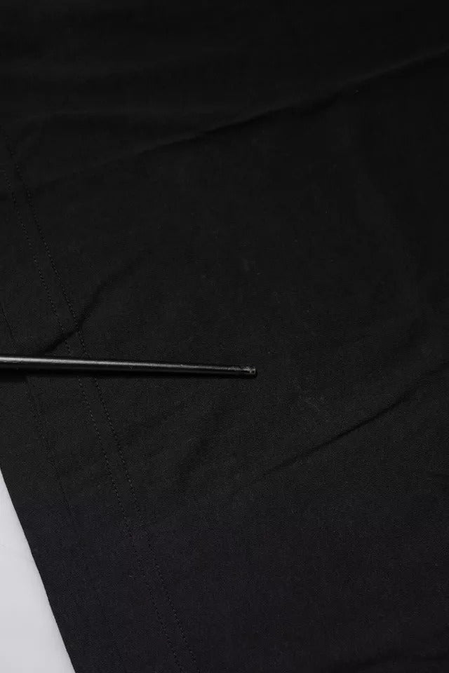Small metal pin on black fabric