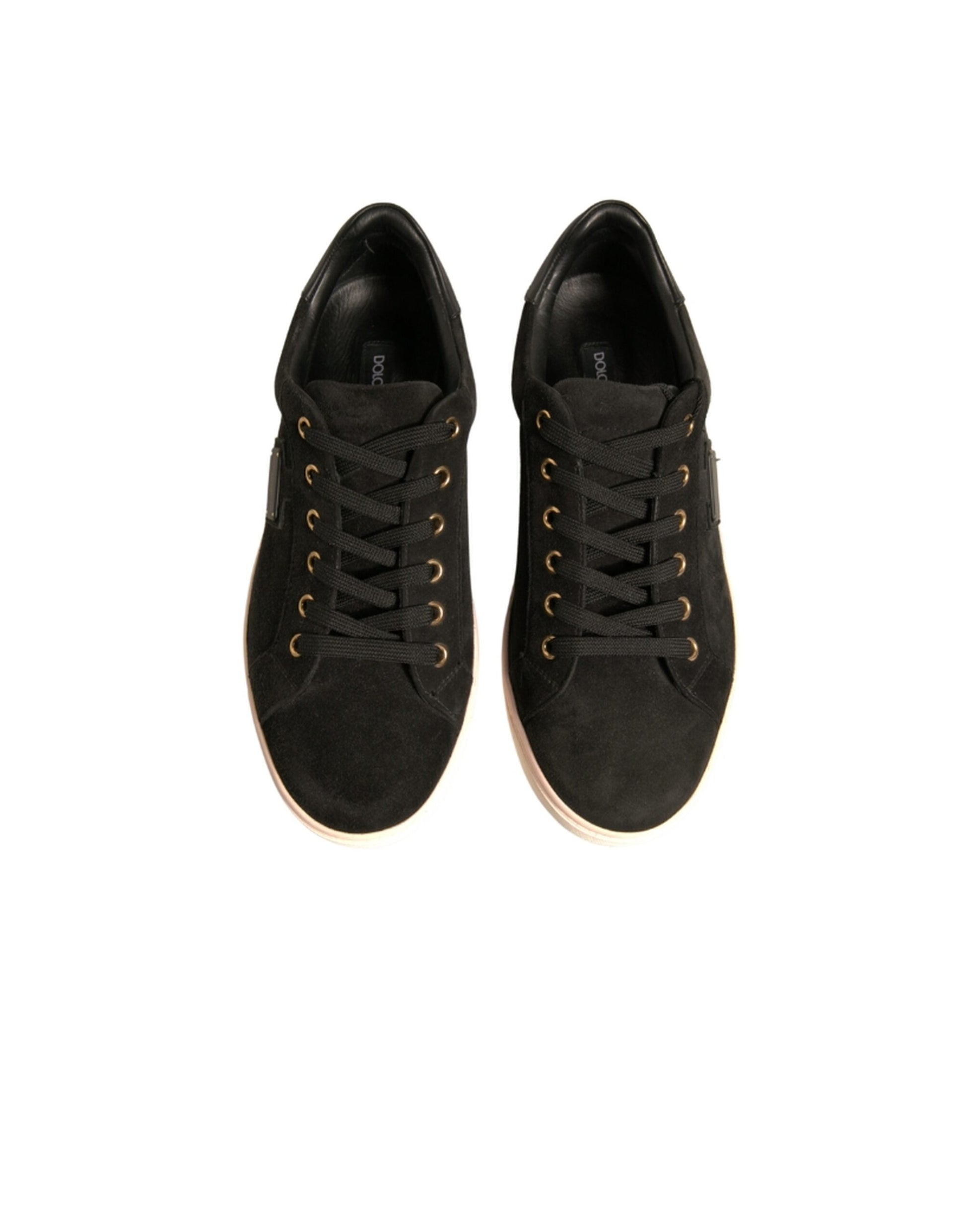Pair of black sneakers with gold laces