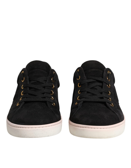 Pair of black sneakers with pink soles