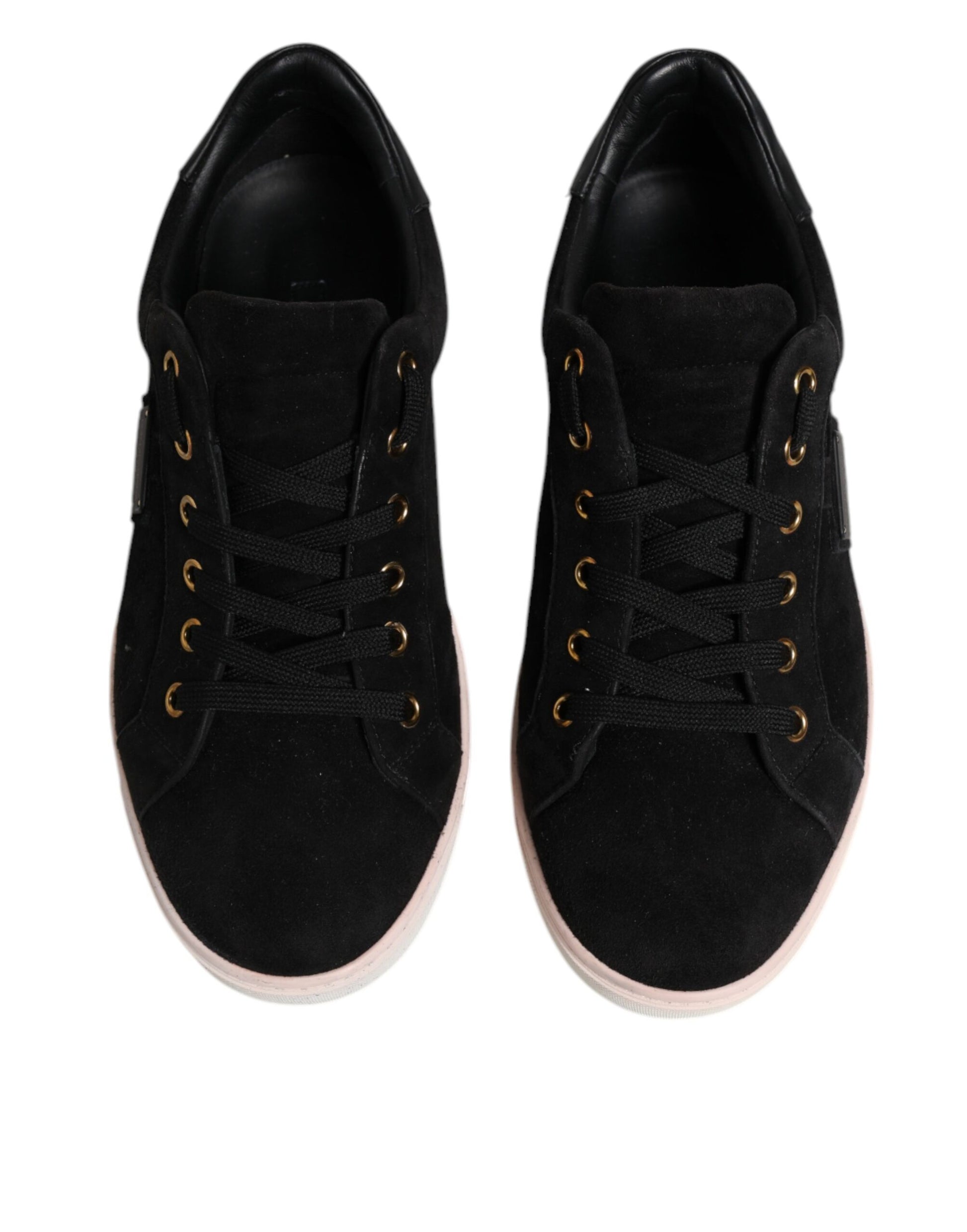 Pair of black sneakers with pink accents
