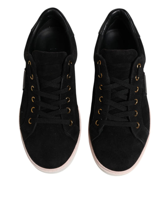 Pair of black sneakers with pink accents