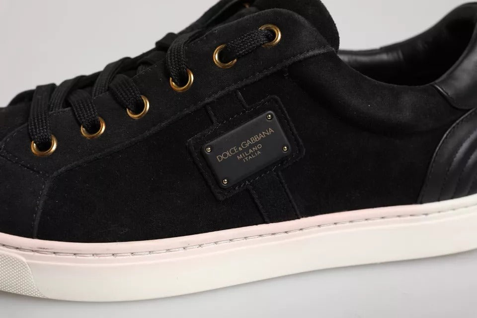 Black sneaker with gold laces and a pink sole
