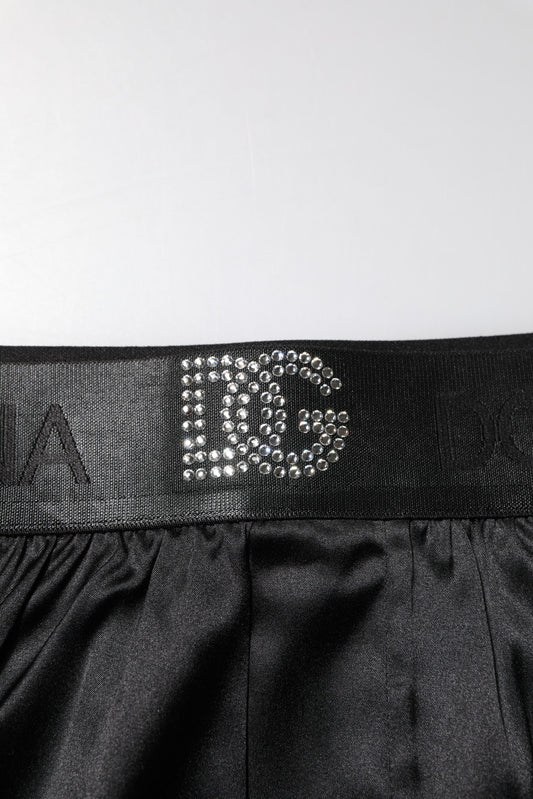 Black shorts with a silver logo on the waistband