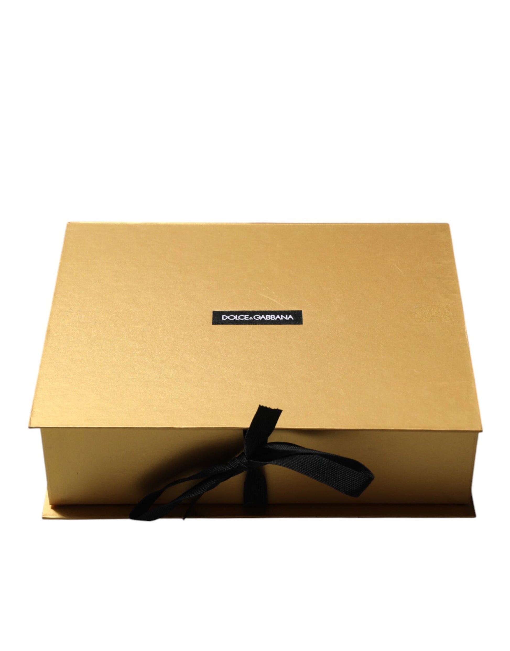 Small gold box with black ribbon tied around it