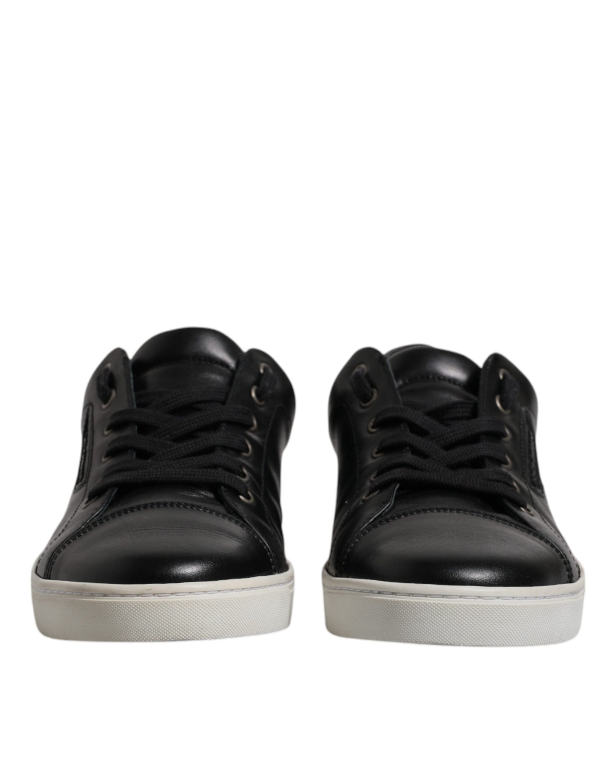 Pair of black leather boots with white soles