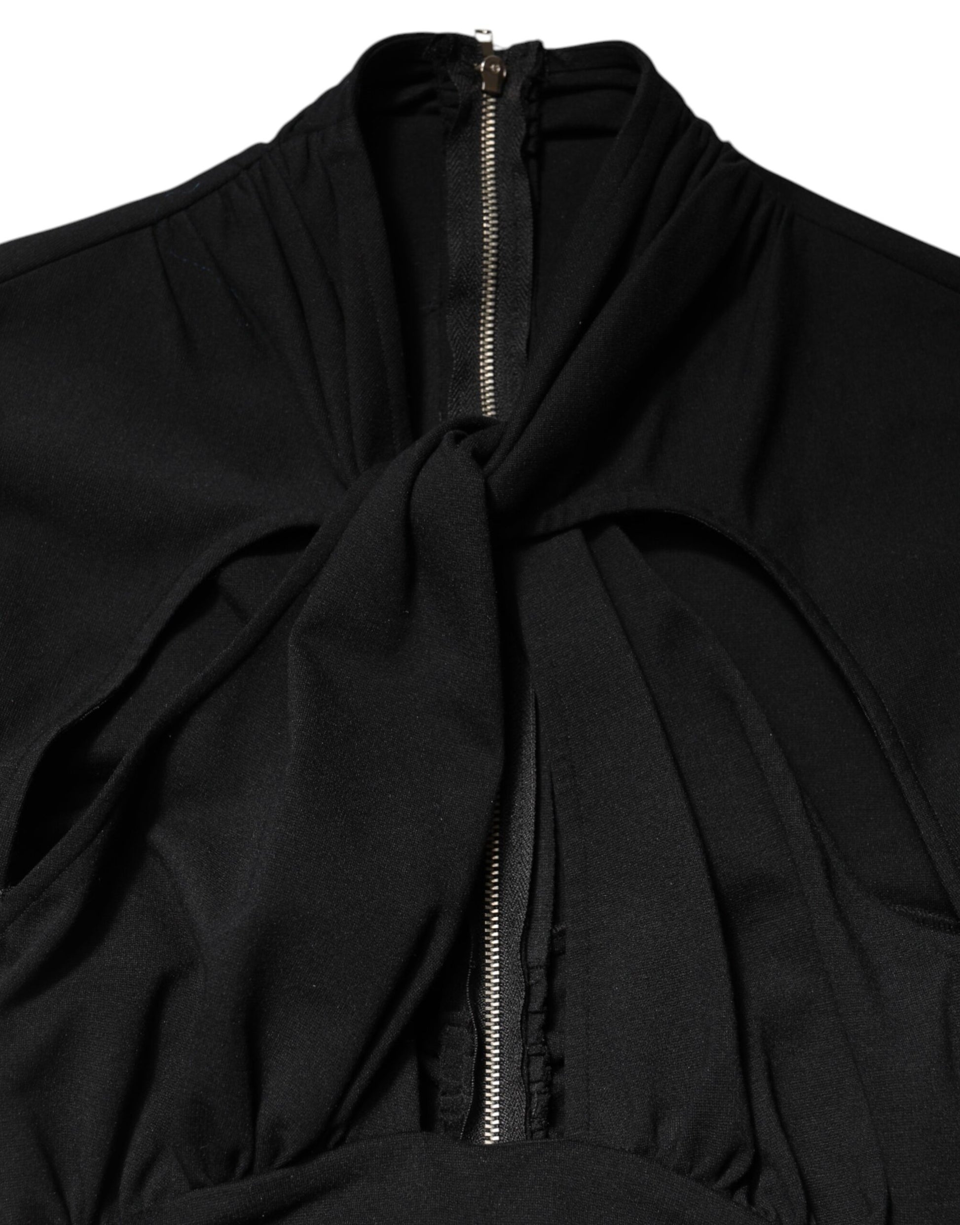 A black midi dress with long sleeves, featuring a zippered front and a tie at the waist