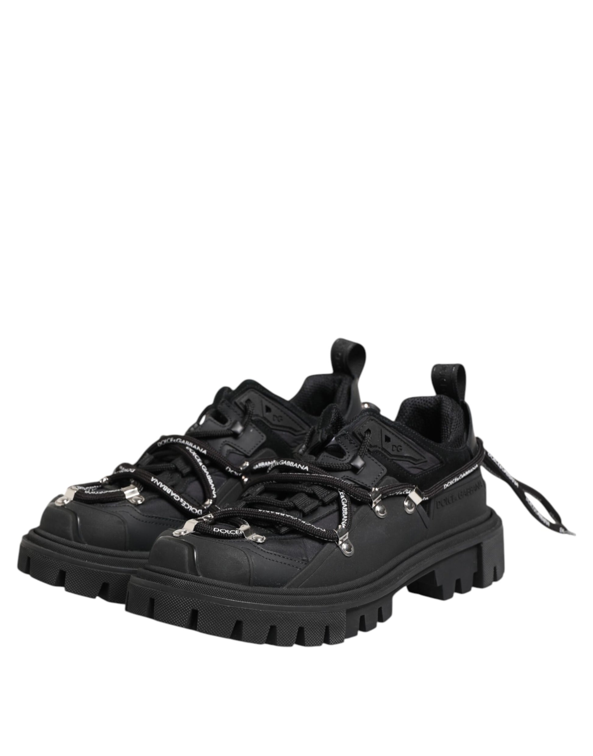 Black hiking boot with laces and metal studs on sole