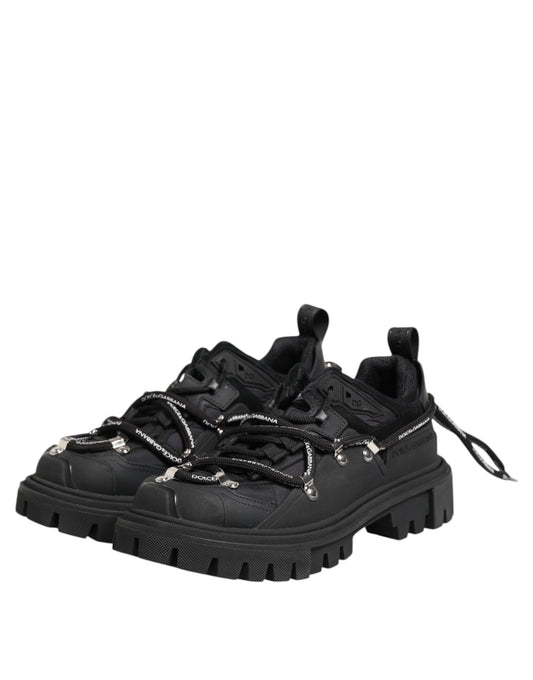 Black hiking boot with laces and metal studs on sole