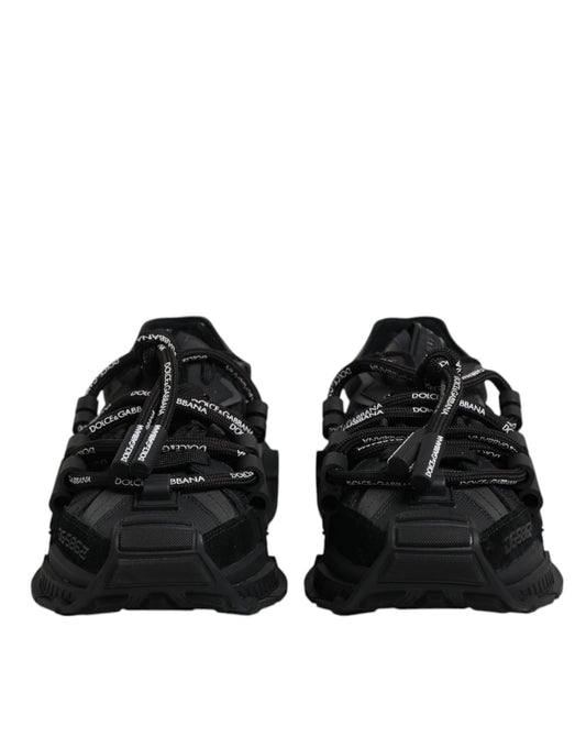Pair of black athletic shoes with white laces