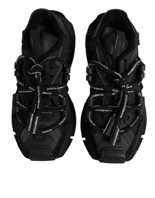 Pair of black athletic shoes with white laces