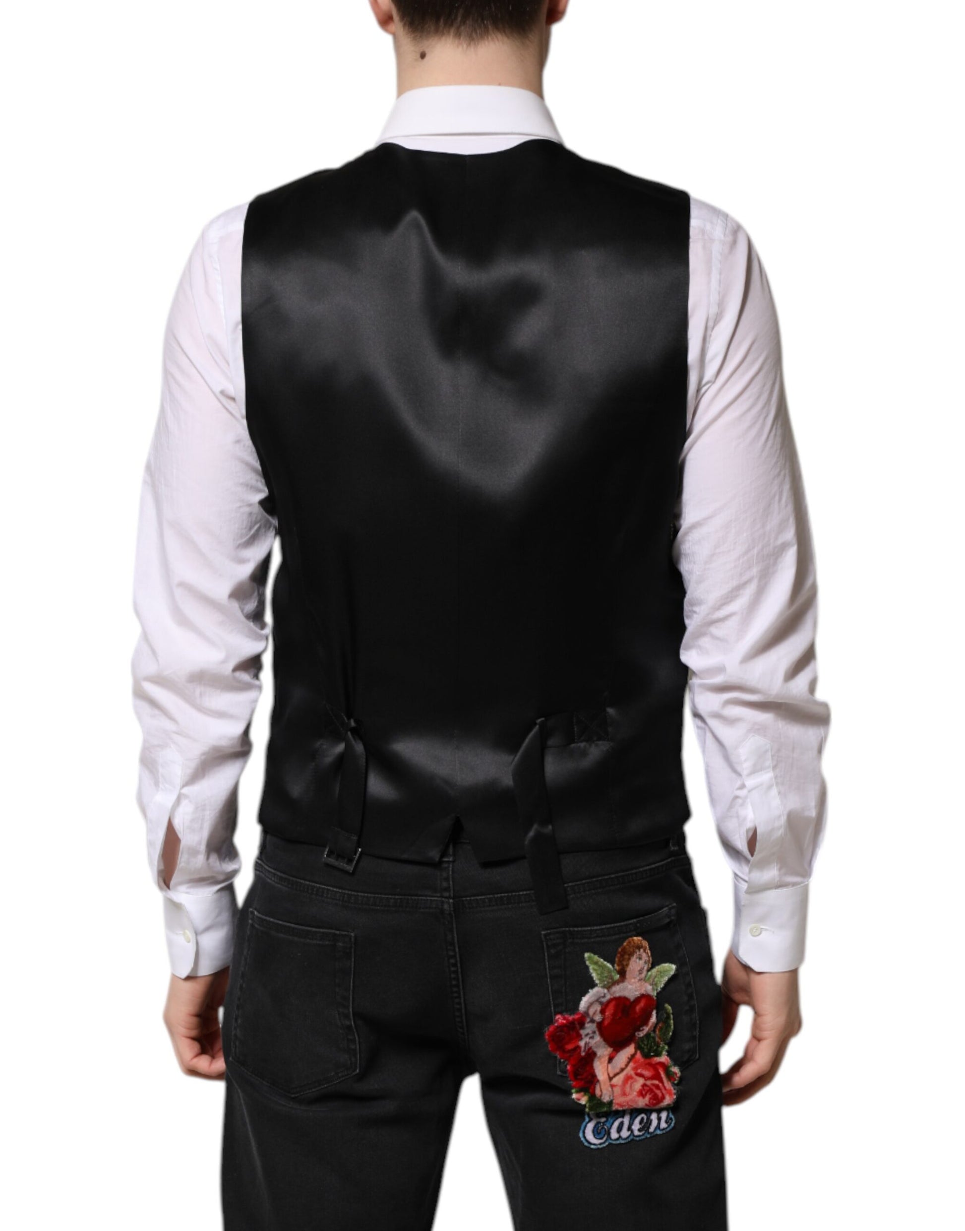 A black lurex vest with a floral embroidery on the back