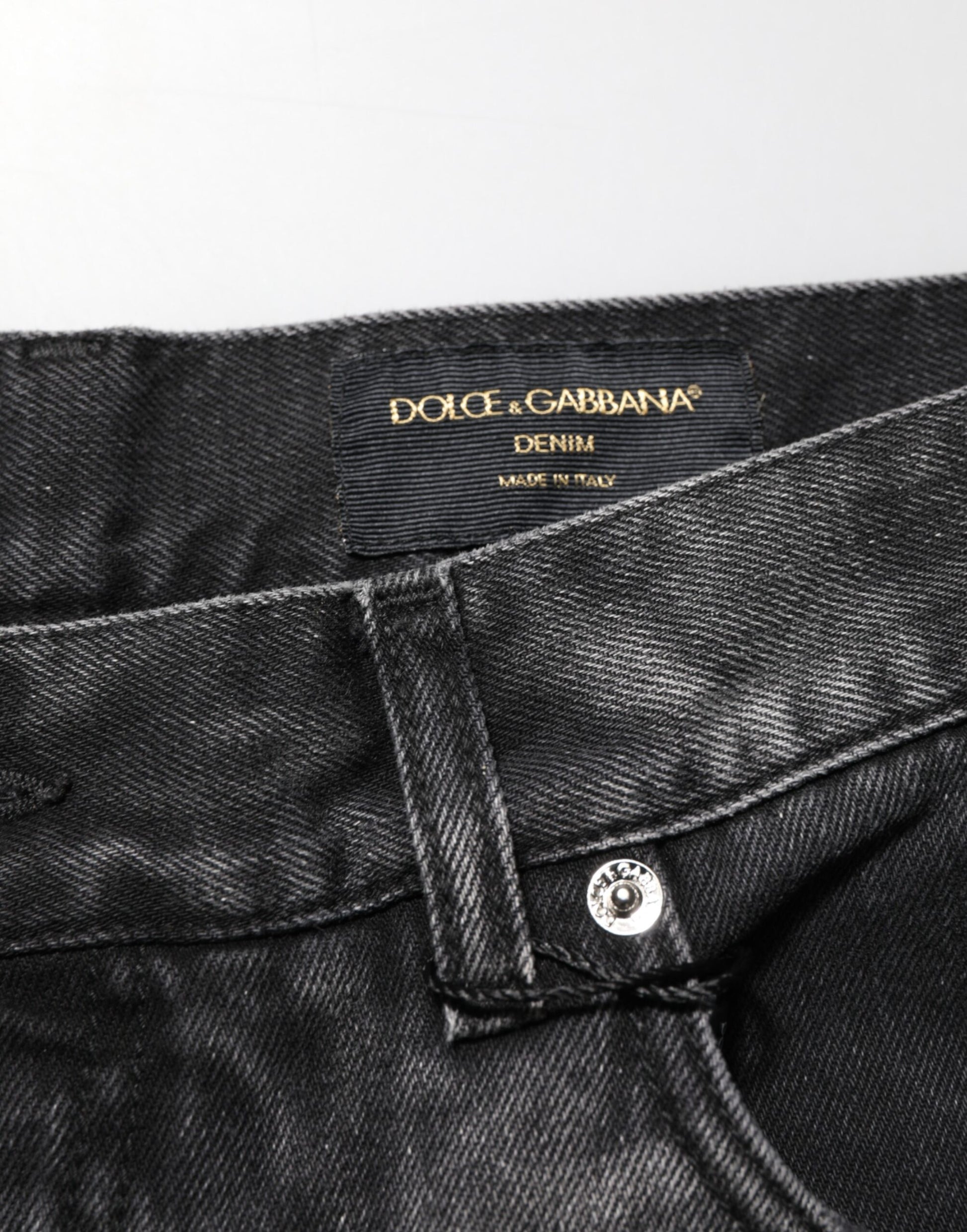Pair of black denim jeans with brand label on waistband