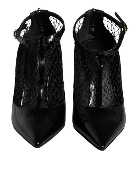Pair of black high heel shoes with a mesh design on the side