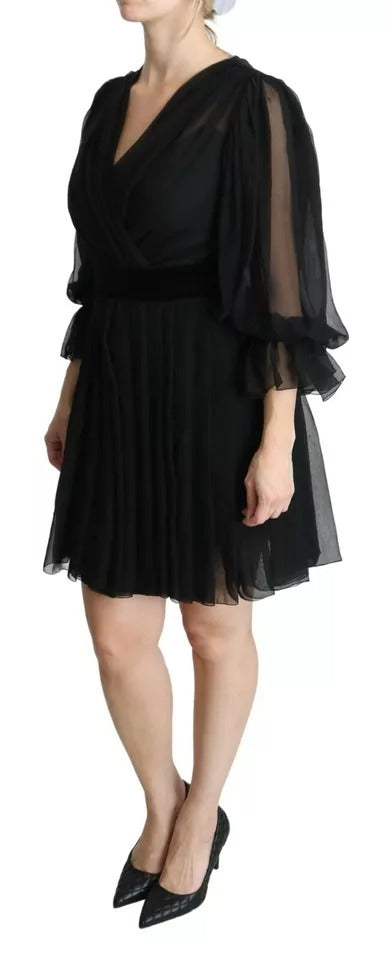 A black mesh pleated mini dress with a silk blend skirt