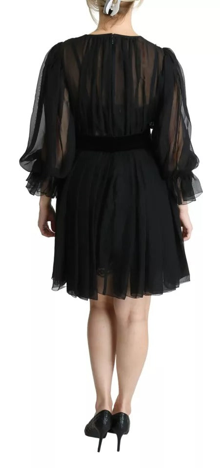 A black mesh pleated mini dress with a silk blend skirt
