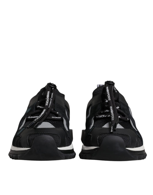 Pair of black athletic shoes with white laces