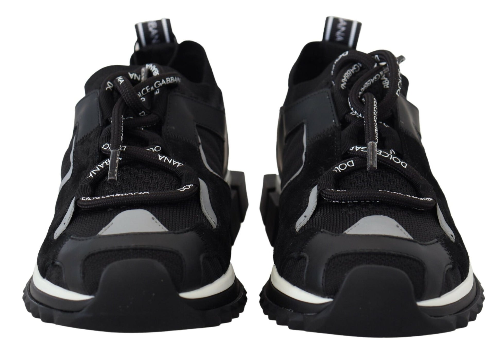 Pair of black and white sneakers with laces tied in a bow