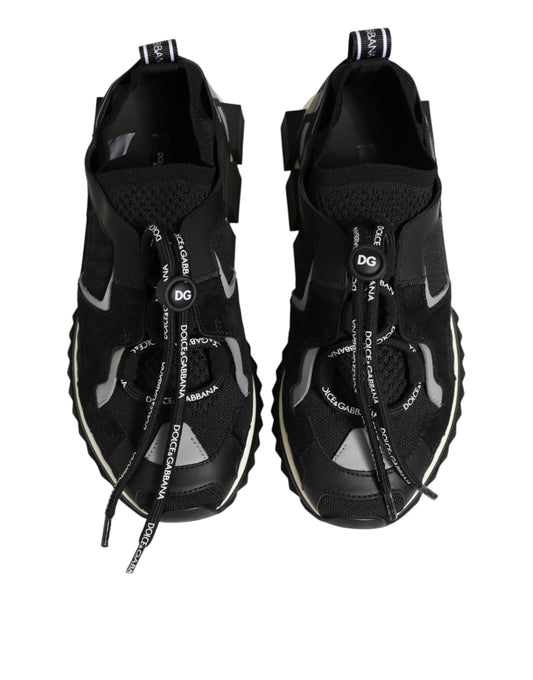 Pair of black athletic shoes with white laces and soles