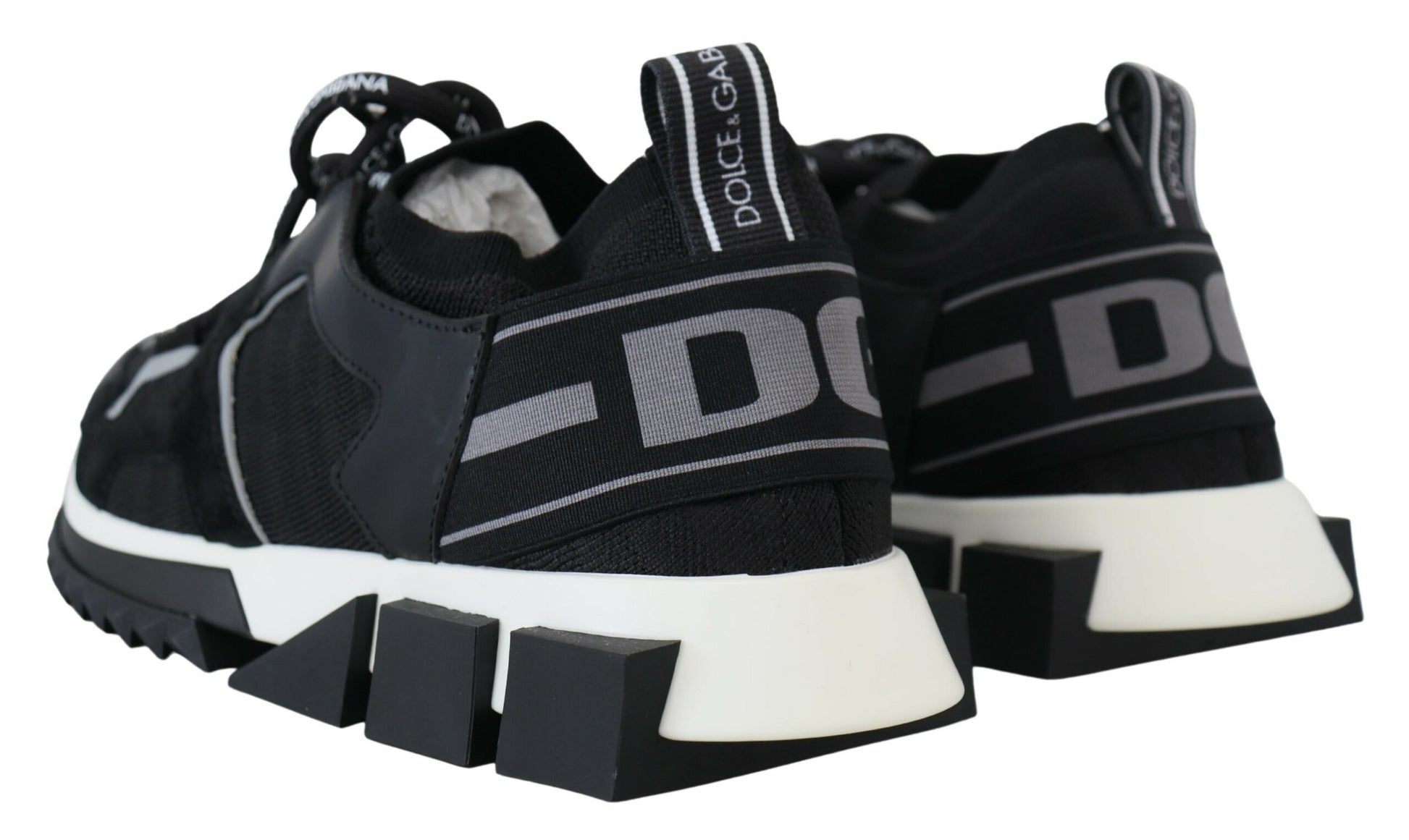 Pair of black and white sneakers with laces and a logo on the side