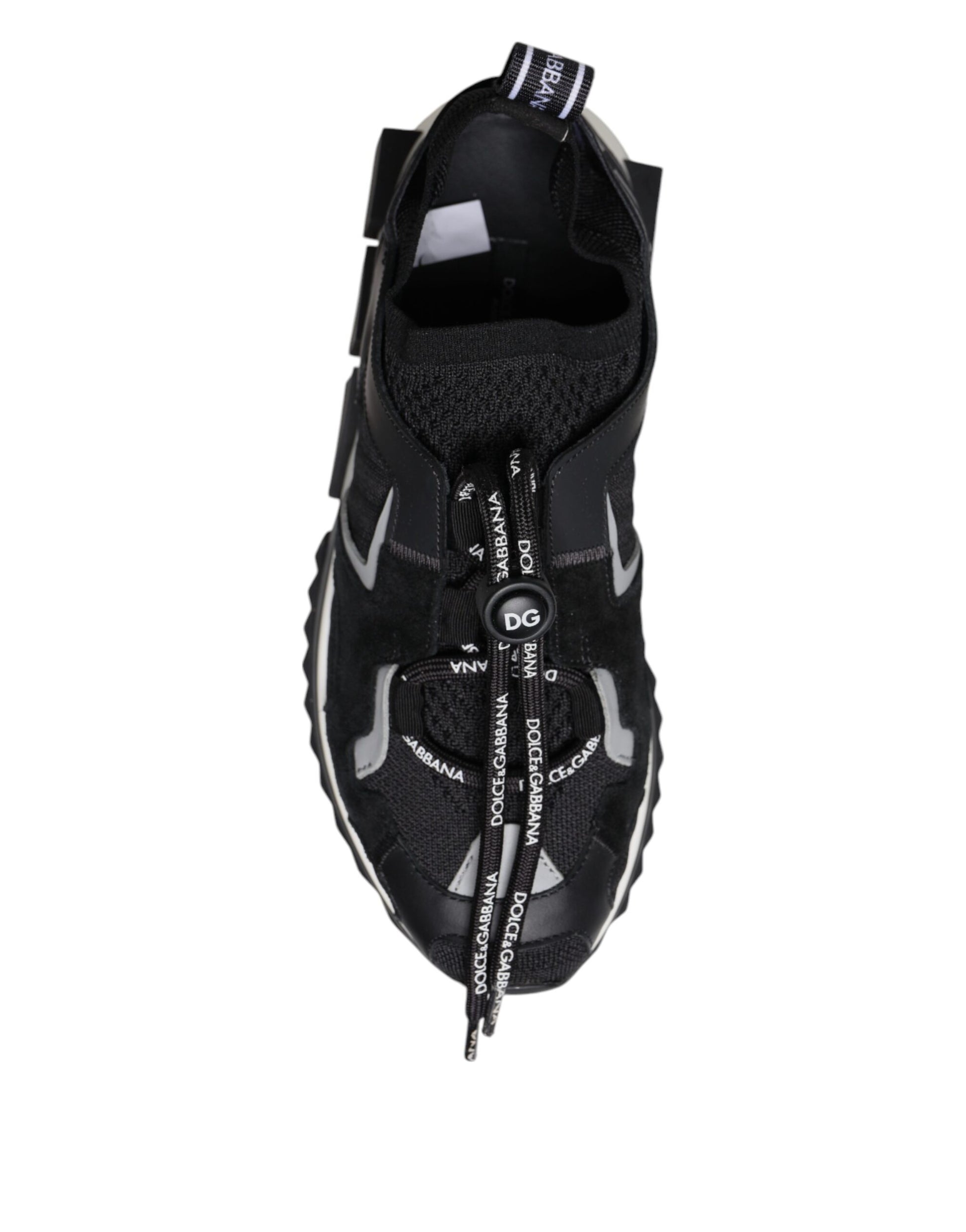 Black athletic shoe with white laces and a black strap across the top