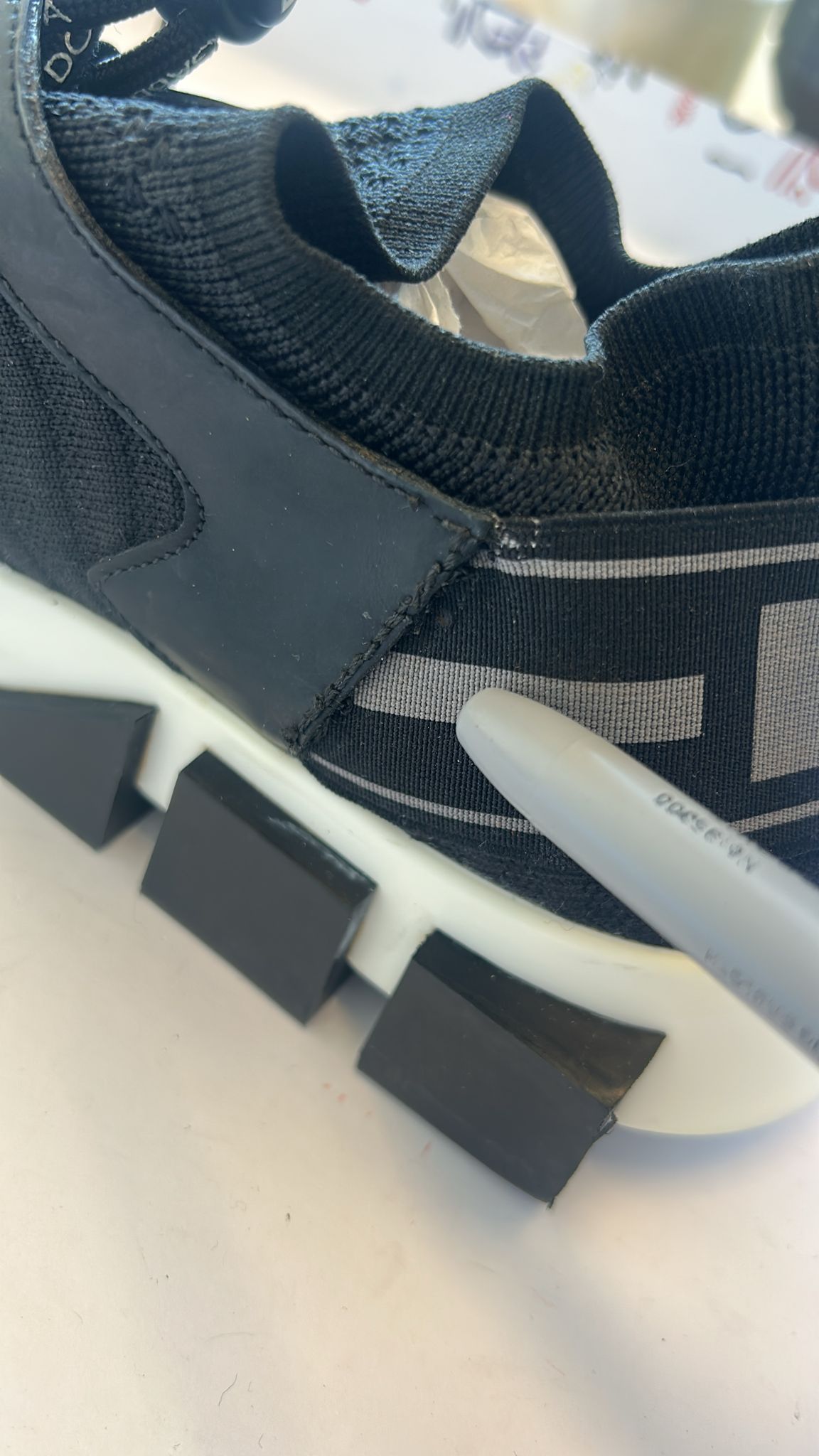 Black and white athletic shoe with laces