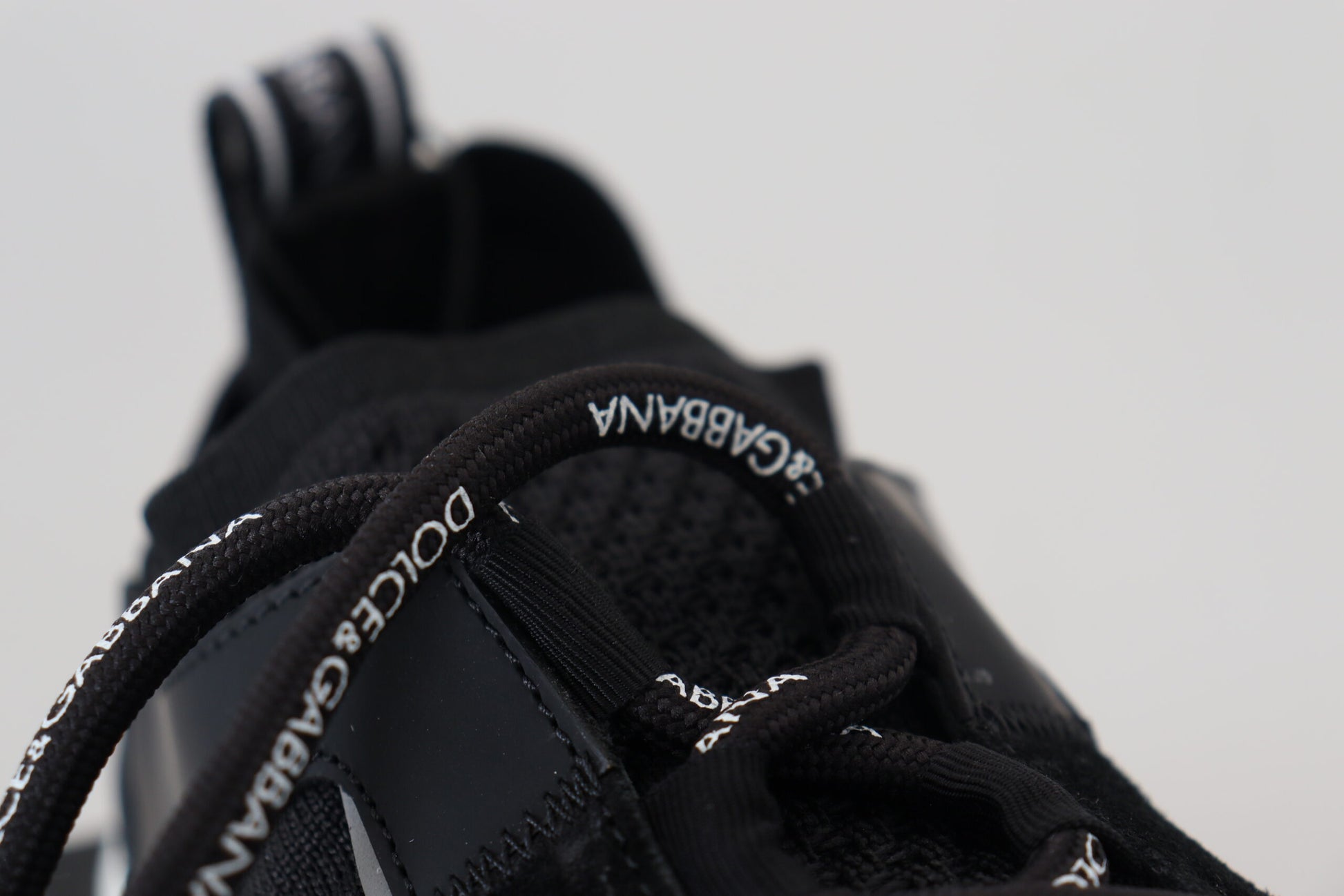 Black and white sneaker with laces tied in a bow