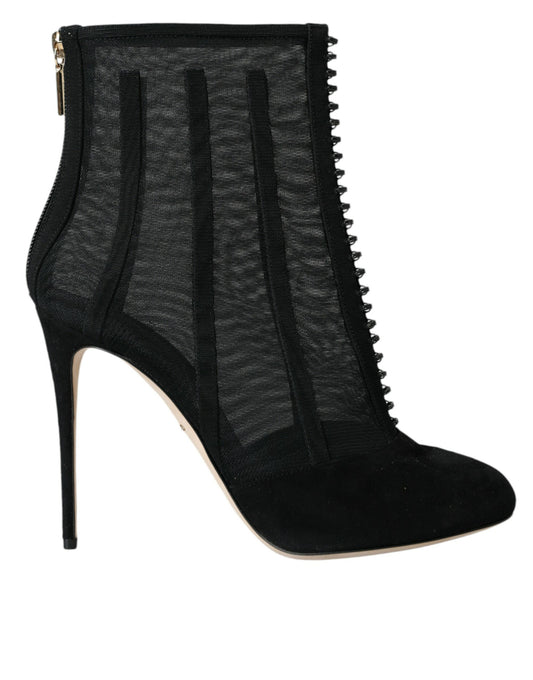 Black suede knee high boots with zipper detailing and a pointed toe