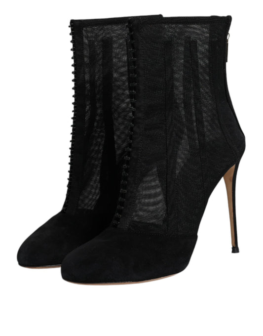 Pair of black boots with embellishments on heels