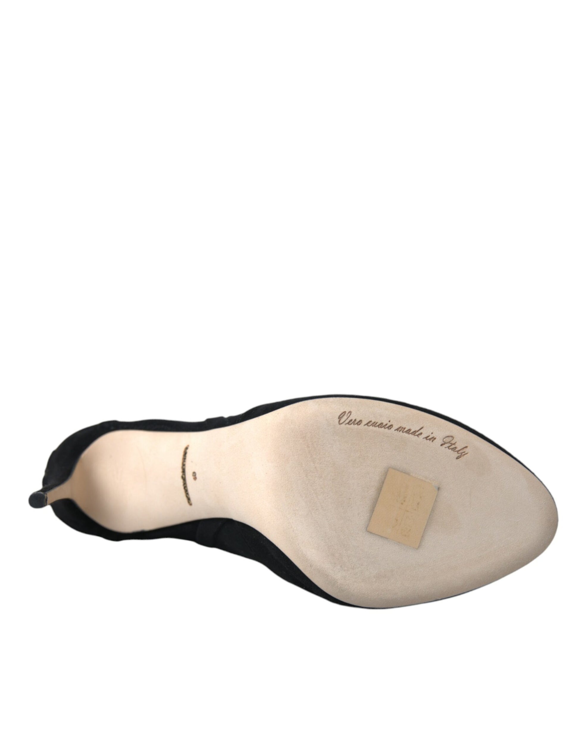 Foot shaped cushion with black trim and a label on it